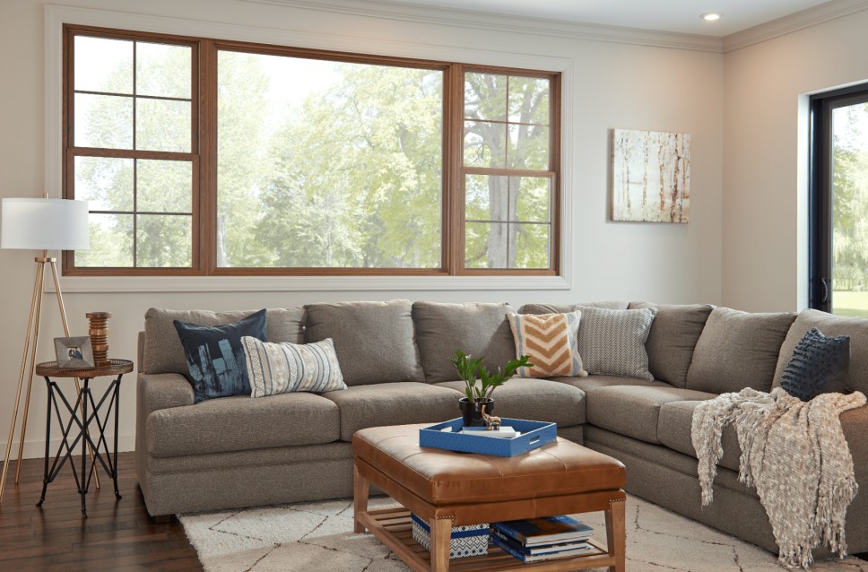 Picture windows behind a couch in a living room
