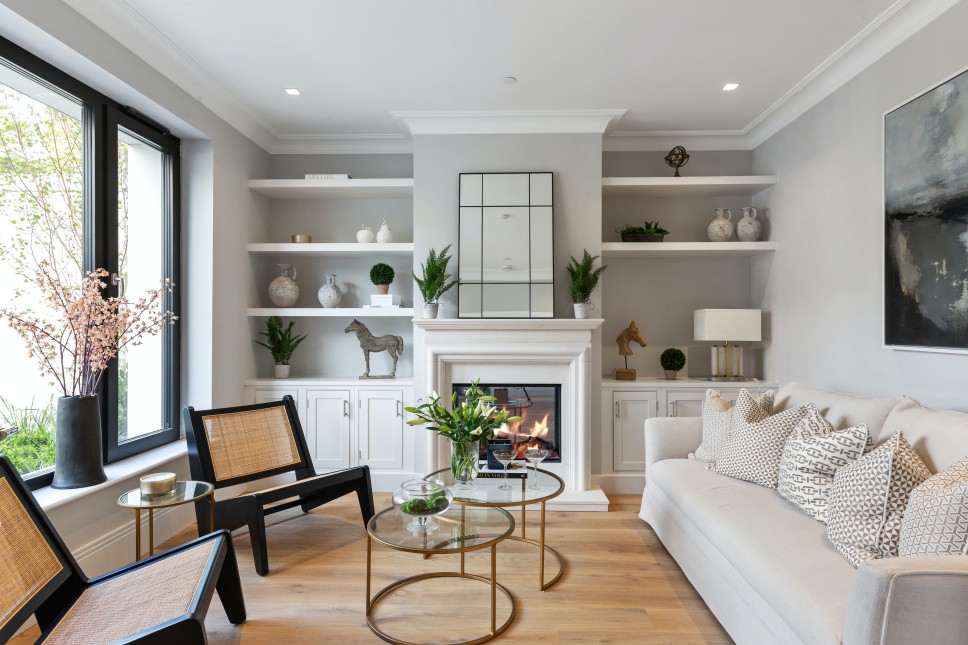 View of the interior of a living room with a modern furniture piece across from a picture window